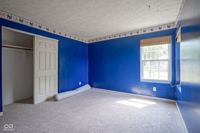 8809 Haddington Dr N, Indianapolis, IN 46256 - unfurnished bedroom featuring a textured ceiling, carpet flooring, and a closet