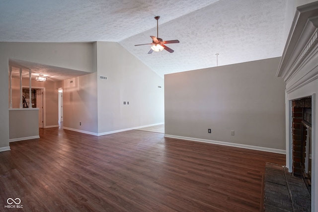 8809 Haddington Dr N, Indianapolis, IN 46256 - unfurnished living room featuring ceiling fan, a brick fireplace, a textured ceiling, dark wood-style flooring, and high vaulted ceiling
