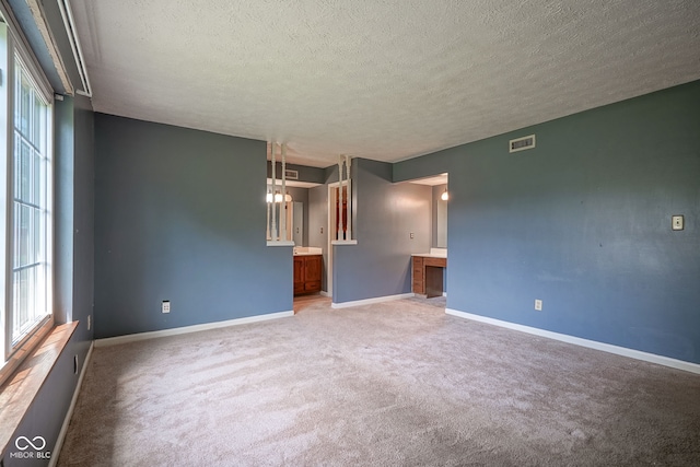 8809 Haddington Dr N, Indianapolis, IN 46256 - unfurnished room featuring a textured ceiling and light colored carpet