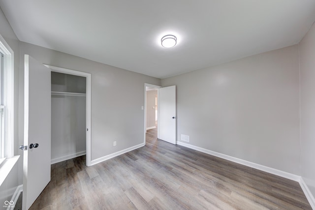 3748 N Olney St, Indianapolis, IN 46218 - unfurnished bedroom featuring wood finished floors and a closet