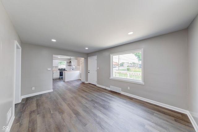 3748 N Olney St, Indianapolis, IN 46218 - unfurnished living room featuring dark wood finished floors and recessed lighting