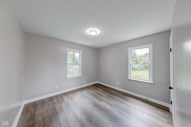 3748 N Olney St, Indianapolis, IN 46218 - spare room featuring wood finished floors and baseboards
