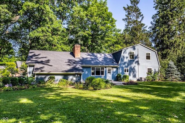 8627 Emerald Ln, Indianapolis, IN 46260 - view of front of house featuring a chimney, a front lawn, a gambrel roof, and a shingled roof