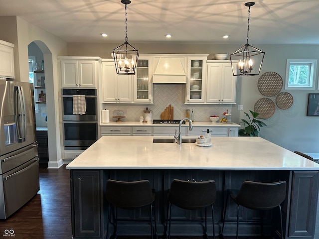 12059 Chapelwood Dr, Fishers, IN 46037 - kitchen with appliances with stainless steel finishes, custom range hood, a chandelier, light countertops, and recessed lighting