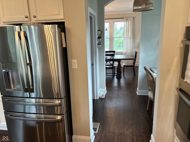 12059 Chapelwood Dr, Fishers, IN 46037 - kitchen featuring appliances with stainless steel finishes, arched walkways, dark wood-style flooring, crown molding, and white cabinetry