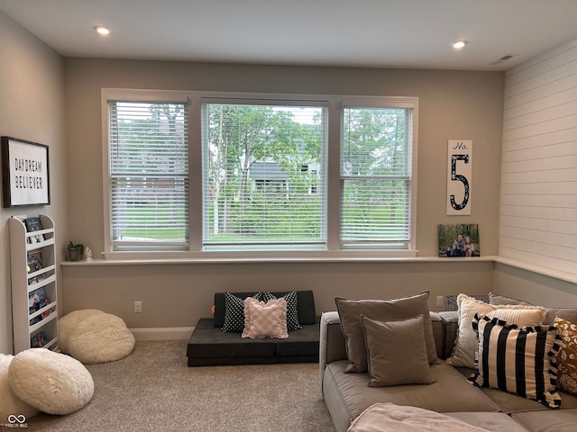12059 Chapelwood Dr, Fishers, IN 46037 - carpeted living area featuring plenty of natural light, wood walls, and recessed lighting