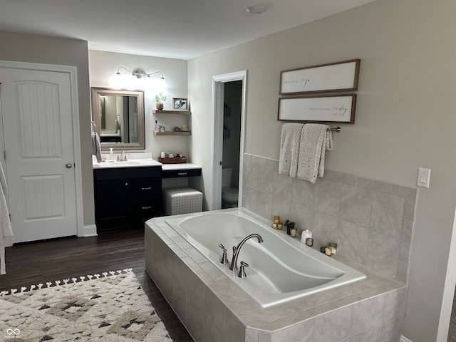 12059 Chapelwood Dr, Fishers, IN 46037 - full bathroom with a garden tub, vanity, and wood finished floors