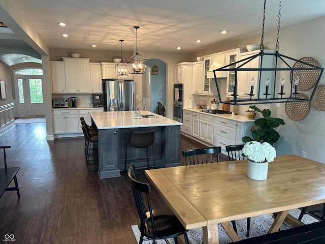 12059 Chapelwood Dr, Fishers, IN 46037 - dining room with a chandelier, dark wood-type flooring, arched walkways, and recessed lighting