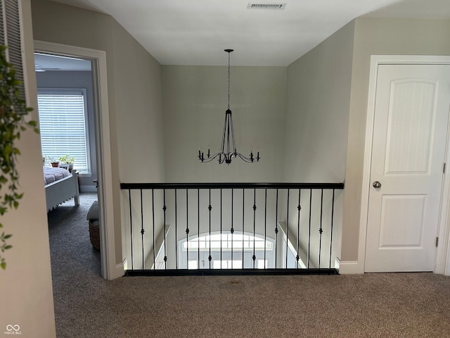 12059 Chapelwood Dr, Fishers, IN 46037 - hallway with carpet and a chandelier
