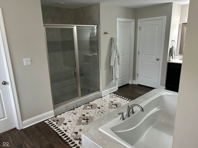 12059 Chapelwood Dr, Fishers, IN 46037 - bathroom featuring a garden tub, a shower stall, vanity, and wood finished floors