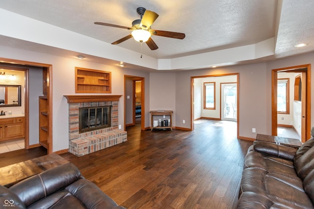 9437 N County Road 225 E, Pittsboro, IN 46167 - living area featuring a fireplace, ceiling fan, dark wood-style floors, a textured ceiling, and recessed lighting