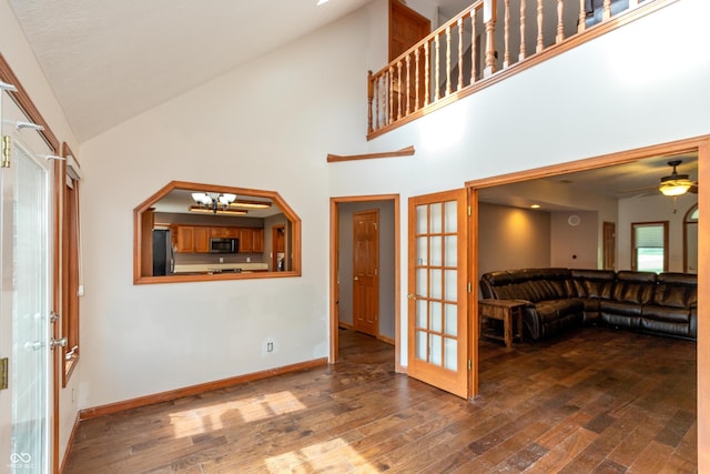 9437 N County Road 225 E, Pittsboro, IN 46167 - unfurnished living room featuring french doors, wood finished floors, a chandelier, high vaulted ceiling, and a ceiling fan