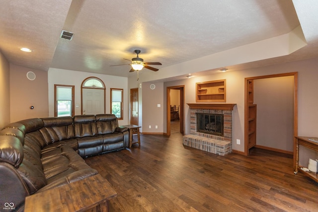 9437 N County Road 225 E, Pittsboro, IN 46167 - living area with wood finished floors, a ceiling fan, a brick fireplace, and a textured ceiling