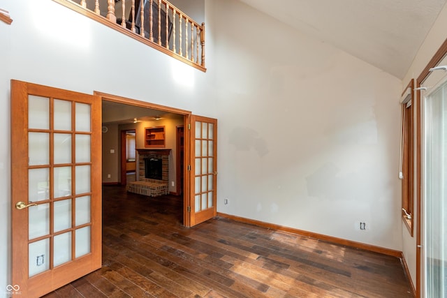 9437 N County Road 225 E, Pittsboro, IN 46167 - unfurnished living room featuring high vaulted ceiling, dark wood-style flooring, french doors, and a brick fireplace