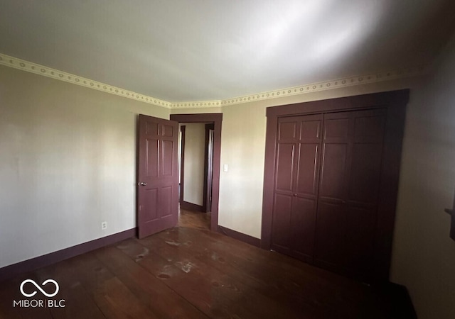 98 E Smithville Rd, Bloomington, IN 47401 - unfurnished bedroom with dark wood-style flooring and a closet