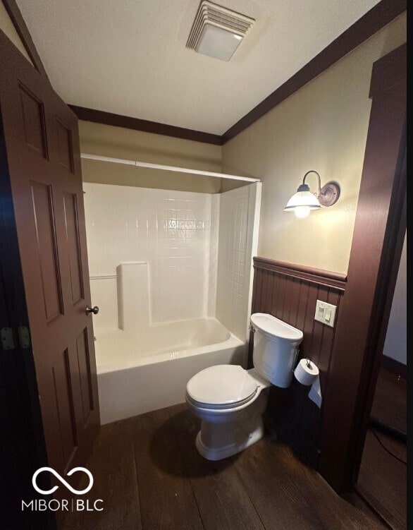 98 E Smithville Rd, Bloomington, IN 47401 - bathroom with shower / washtub combination, wood finished floors, crown molding, and a wainscoted wall