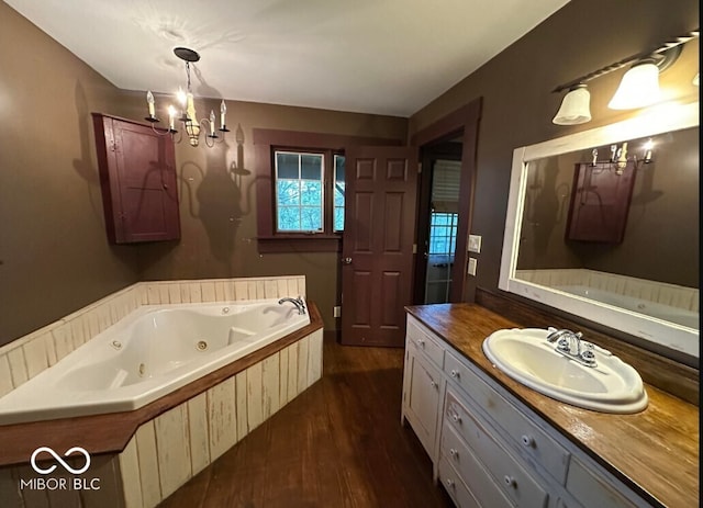 98 E Smithville Rd, Bloomington, IN 47401 - full bathroom with wood finished floors, a jetted tub, vanity, and a chandelier