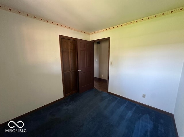 98 E Smithville Rd, Bloomington, IN 47401 - unfurnished room with dark colored carpet and baseboards