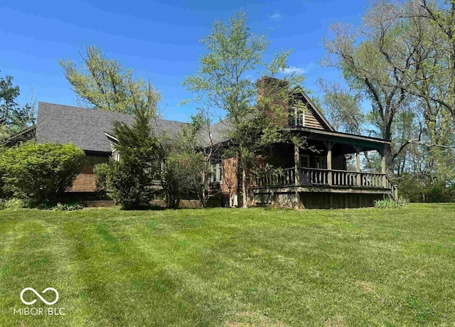 98 E Smithville Rd, Bloomington, IN 47401 - view of front of property featuring a front lawn, a chimney, and covered porch