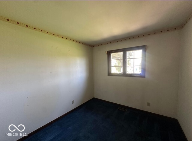 98 E Smithville Rd, Bloomington, IN 47401 - empty room with dark colored carpet and baseboards