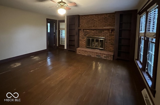 98 E Smithville Rd, Bloomington, IN 47401 - unfurnished living room featuring dark wood finished floors, a brick fireplace, and ceiling fan