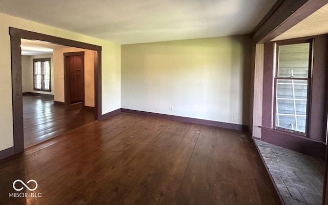 98 E Smithville Rd, Bloomington, IN 47401 - unfurnished room with dark wood-type flooring and baseboards
