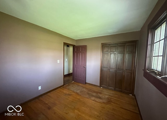 98 E Smithville Rd, Bloomington, IN 47401 - unfurnished bedroom with wood finished floors and a closet
