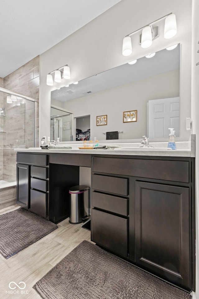 1448 Willow Tree Ln, Sheridan, IN 46069 - bathroom with a stall shower, double vanity, and wood finished floors