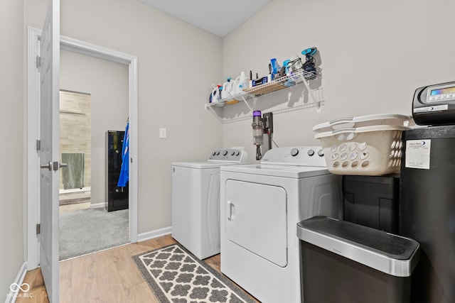 1448 Willow Tree Ln, Sheridan, IN 46069 - laundry room with light wood finished floors and separate washer and dryer