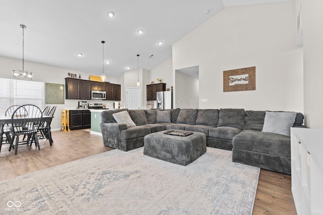 1448 Willow Tree Ln, Sheridan, IN 46069 - living room featuring light wood-style flooring, high vaulted ceiling, a chandelier, and recessed lighting