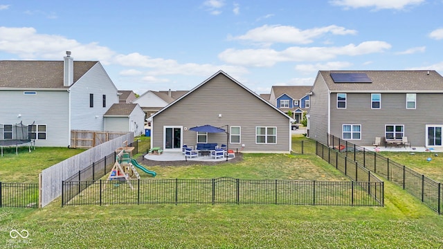 1448 Willow Tree Ln, Sheridan, IN 46069 - rear view of property featuring a trampoline, a patio area, a playground, and a fenced backyard