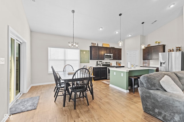 1448 Willow Tree Ln, Sheridan, IN 46069 - dining area featuring light wood finished floors, lofted ceiling, and recessed lighting
