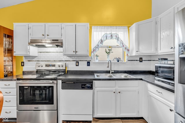 1058 Creekwood Ln, Franklin, IN 46131 - kitchen with stainless steel appliances, extractor fan, dark countertops, white cabinetry, and lofted ceiling