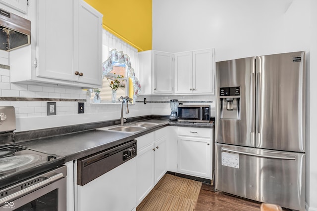 1058 Creekwood Ln, Franklin, IN 46131 - kitchen with stainless steel appliances, dark countertops, white cabinetry, and a towering ceiling