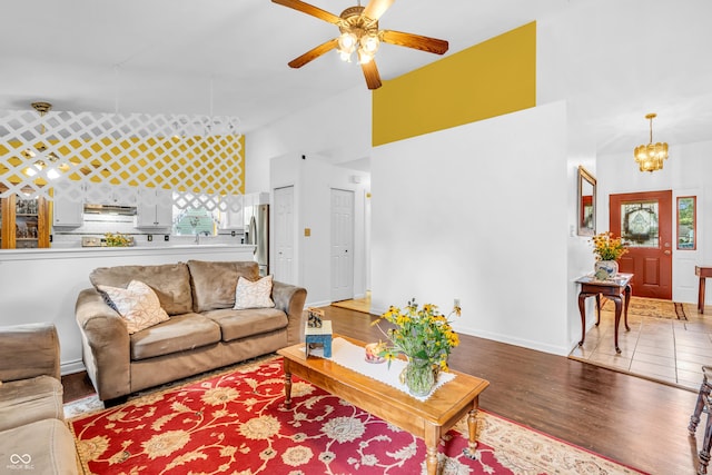 1058 Creekwood Ln, Franklin, IN 46131 - living area with ceiling fan, a chandelier, wood finished floors, a high ceiling, and healthy amount of natural light