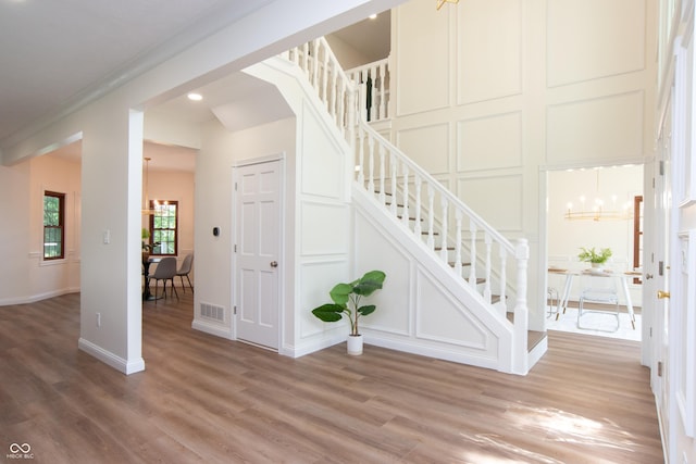 10630 Thorny Rdg Trce, Fishers, IN 46037 - staircase featuring a decorative wall, wood finished floors, a chandelier, ornamental molding, and recessed lighting
