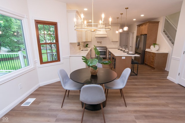 10630 Thorny Rdg Trce, Fishers, IN 46037 - dining space with a chandelier, light wood finished floors, and recessed lighting