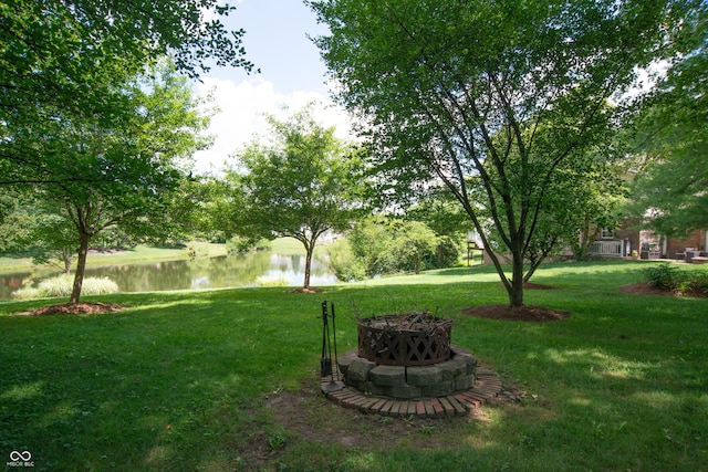 10630 Thorny Rdg Trce, Fishers, IN 46037 - view of green lawn with a fire pit and a water view