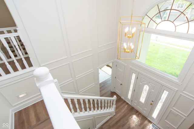 10630 Thorny Rdg Trce, Fishers, IN 46037 - foyer with a chandelier, a decorative wall, dark wood-style flooring, and plenty of natural light
