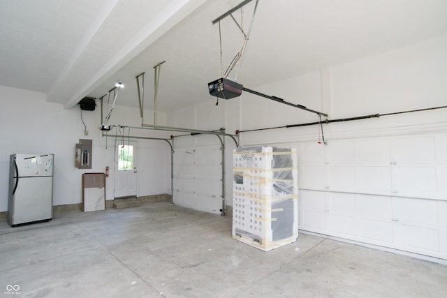 10630 Thorny Rdg Trce, Fishers, IN 46037 - garage with freestanding refrigerator, electric panel, and a garage door opener
