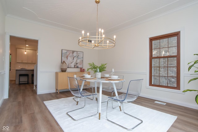 10630 Thorny Rdg Trce, Fishers, IN 46037 - dining area featuring wood finished floors, ornamental molding, and a chandelier