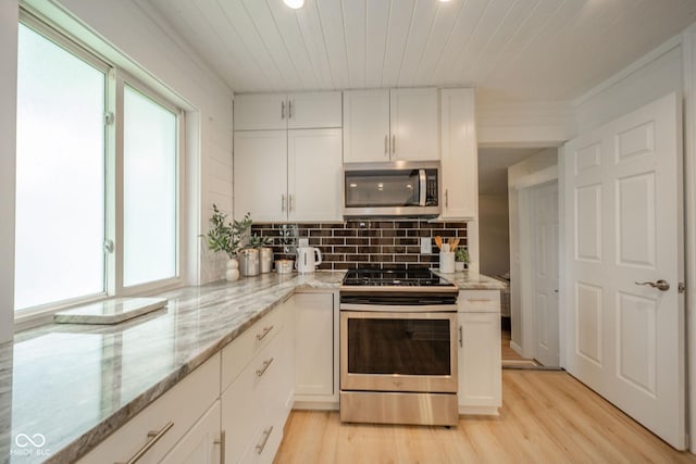 107 Pasadena Rd, Noblesville, IN 46062 - kitchen featuring appliances with stainless steel finishes, light wood-type flooring, white cabinetry, backsplash, and light stone counters