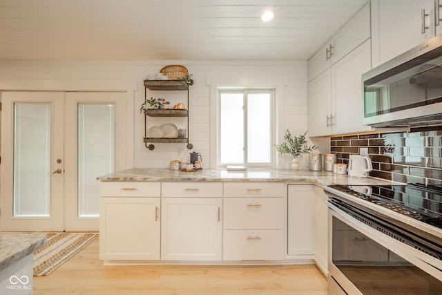 107 Pasadena Rd, Noblesville, IN 46062 - kitchen with stainless steel appliances, open shelves, white cabinetry, and light stone countertops