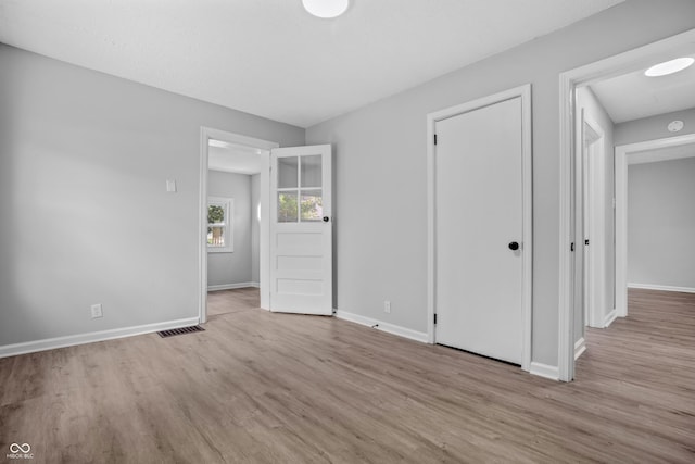 184 N Post Rd, Indianapolis, IN 46219 - unfurnished bedroom featuring wood finished floors and a closet