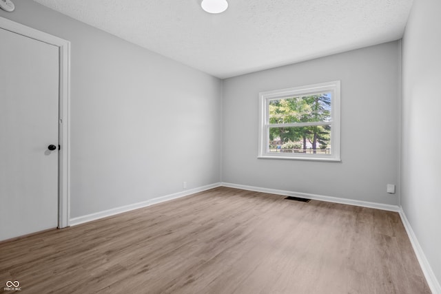 184 N Post Rd, Indianapolis, IN 46219 - empty room featuring wood finished floors and a textured ceiling