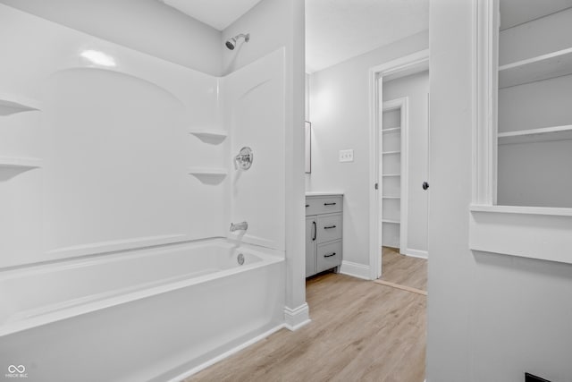 184 N Post Rd, Indianapolis, IN 46219 - full bath featuring tub / shower combination, wood finished floors, a walk in closet, and vanity