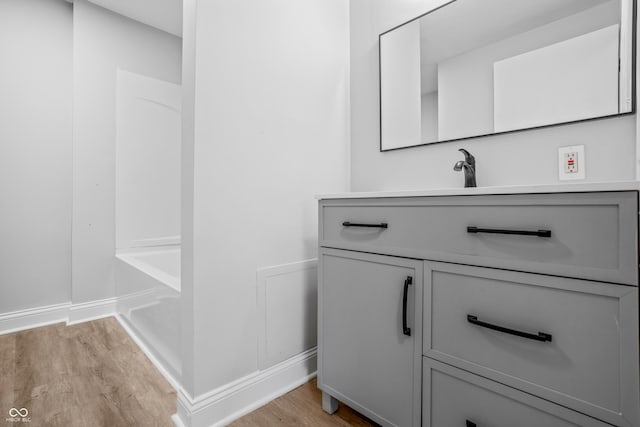 184 N Post Rd, Indianapolis, IN 46219 - bathroom featuring wood finished floors, vanity, a bath, and a shower