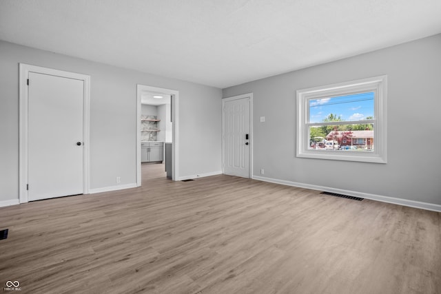 184 N Post Rd, Indianapolis, IN 46219 - unfurnished living room featuring wood finished floors
