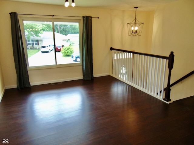 4546 Laclede St, Indianapolis, IN 46221 - unfurnished room with a chandelier and wood finished floors