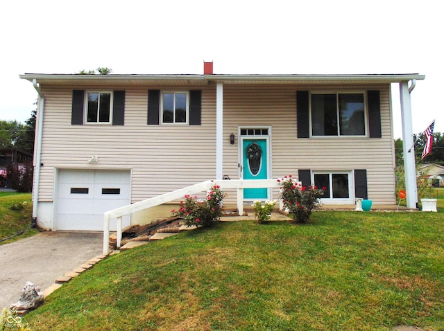 4546 Laclede St, Indianapolis, IN 46221 - raised ranch featuring a garage, a front yard, and driveway